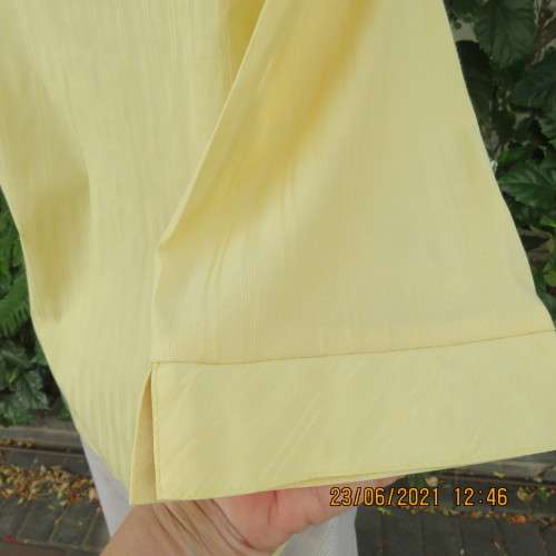 Trendy buttercup yellow button down top with embossed stripes size 42/18.Elbow length sleeves.As new