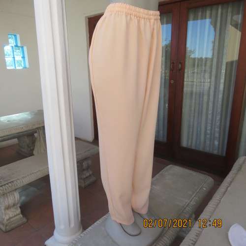 Fresh,easy to wear peach colour pants with tapered legs in 100% crepe polyester. Size 42 to 44