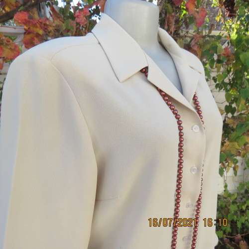 Stylish rich cream button down top in textured polyester.With flare sleeve cuffs. Size 42/18. As new