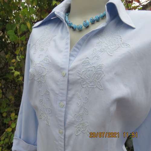 High quality powder blue button down top with tasteful floral front embroidery. Size 38 to 40.By M H