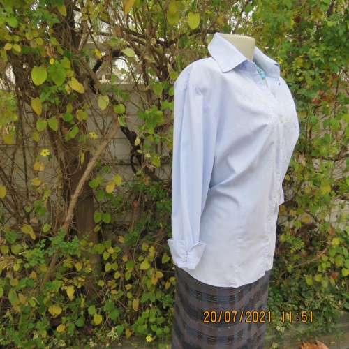 High quality powder blue button down top with tasteful floral front embroidery. Size 38 to 40.By M H