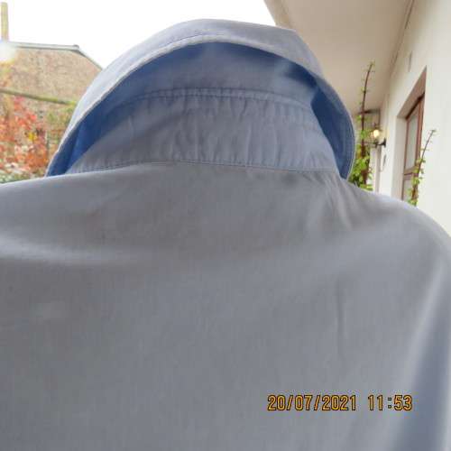 High quality powder blue button down top with tasteful floral front embroidery. Size 38 to 40.By M H