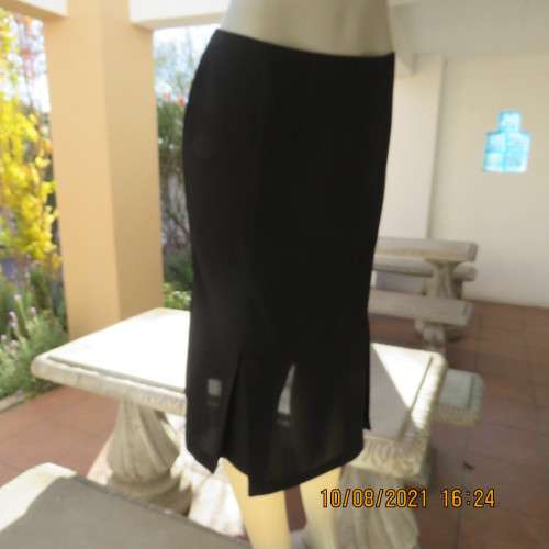 High quality as new black FINNEGANS skirt in size 34/10. Bandless.In 7 panels with 2 inverted pleats