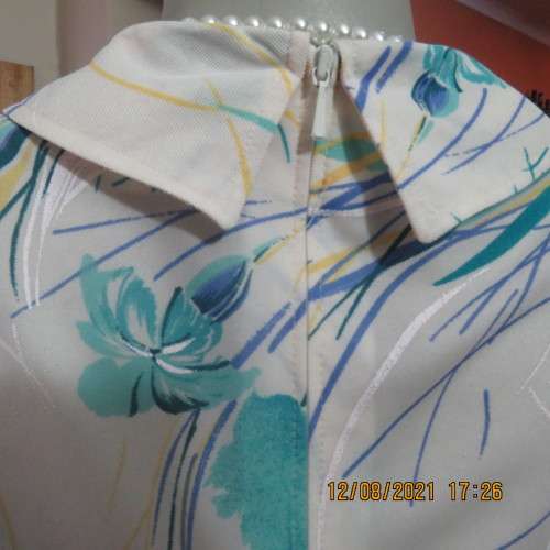 Ageless princess style short sleeve vintage dress by DELSWA size 42/18.White with turquoise flowers.