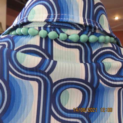Geometric printed short sleeve top in blue shades with green accents. By DAVLEY size 46/22.As new