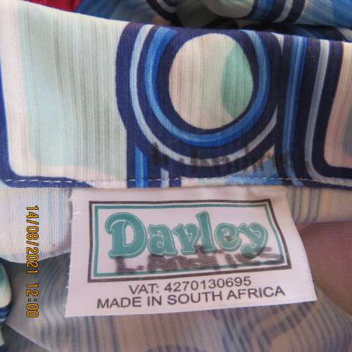 Geometric printed short sleeve top in blue shades with green accents. By DAVLEY size 46/22.As new