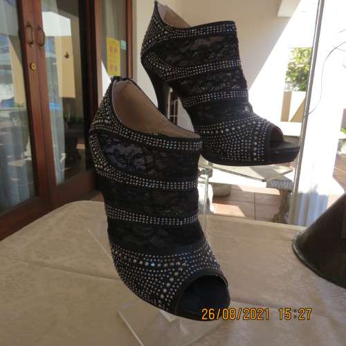 Pair of shiny black ankle summer boots with lace and studs. Stiletto heels.Open toes.By ORBIT size 7