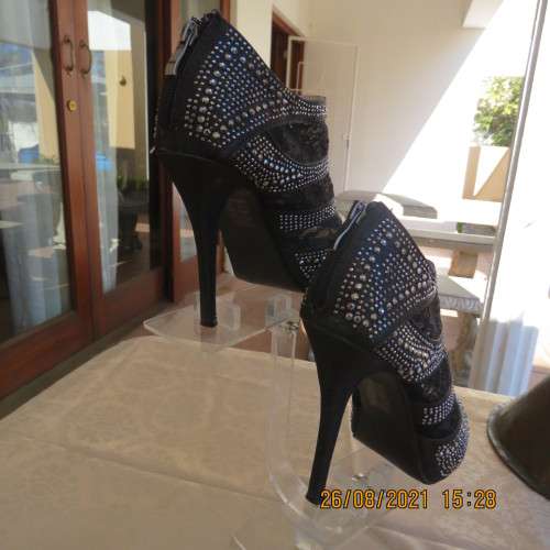 Pair of shiny black ankle summer boots with lace and studs. Stiletto heels.Open toes.By ORBIT size 7