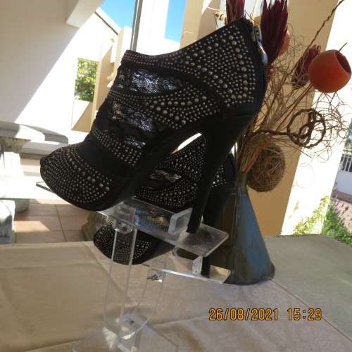Pair of shiny black ankle summer boots with lace and studs. Stiletto heels.Open toes.By ORBIT size 7
