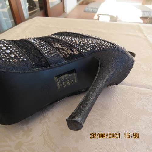 Pair of shiny black ankle summer boots with lace and studs. Stiletto heels.Open toes.By ORBIT size 7