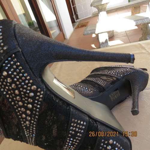 Pair of shiny black ankle summer boots with lace and studs. Stiletto heels.Open toes.By ORBIT size 7