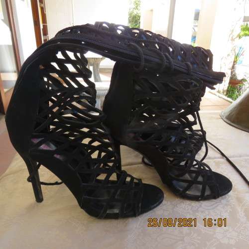 Knee length pair of black criss cross boots with long back zip. Size 7 by Legit.As new.Open toes.