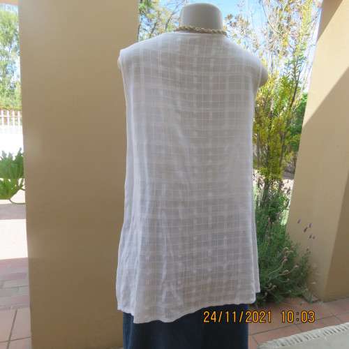 Cool white sleeveless cheese cloth top.Size 38/14.Close with buttons and loops.High side slits.