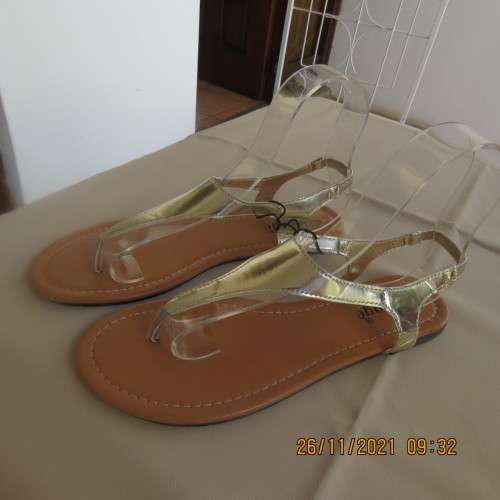 Pair of gold colour flat toe post sandals with straps at back. By IMAGE size 6. Never used.Brand new
