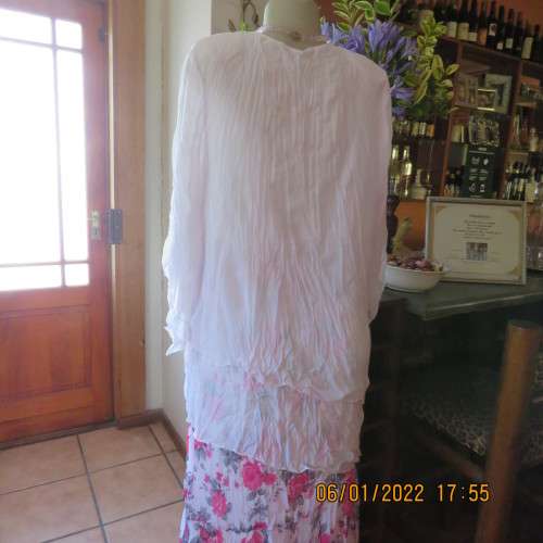 Stunning white double layer creased polyester asymmetrical top with elbow angel sleeves.Size 40/42.