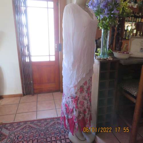 Stunning white double layer creased polyester asymmetrical top with elbow angel sleeves.Size 40/42.