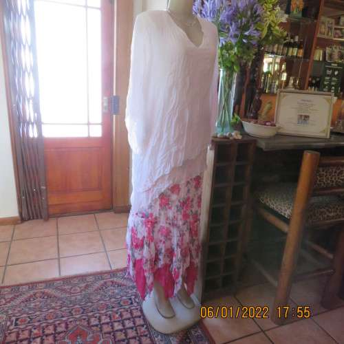 Stunning white double layer creased polyester asymmetrical top with elbow angel sleeves.Size 40/42.