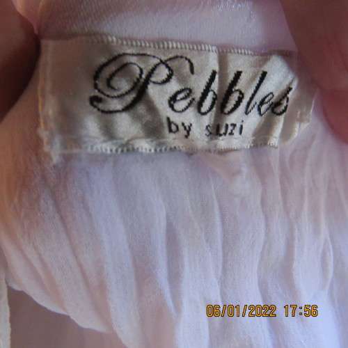 Stunning white double layer creased polyester asymmetrical top with elbow angel sleeves.Size 40/42.