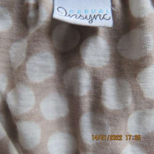 Cool ecru colour sleeveless top with white opaque dots.Size 32/8. Front cross overlay.As new