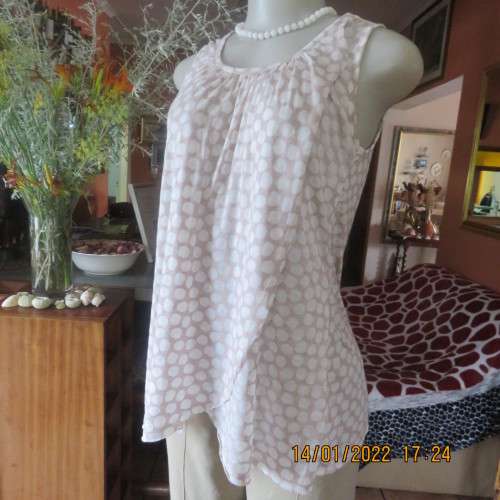 Cool ecru colour sleeveless top with white opaque dots.Size 32/8. Front cross overlay.As new