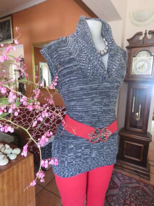 Stylish black/white mottled long acrylic knit sleeveless top.Foldover fireside collar.Size 36/12.