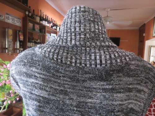 Stylish black/white mottled long acrylic knit sleeveless top.Foldover fireside collar.Size 36/12.