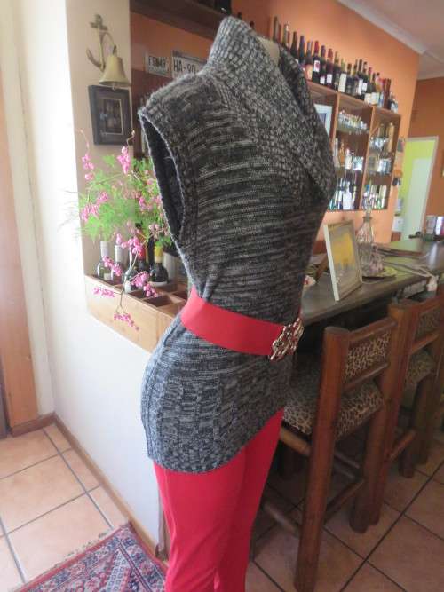 Stylish black/white mottled long acrylic knit sleeveless top.Foldover fireside collar.Size 36/12.