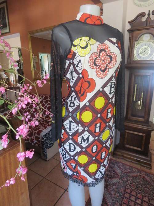 Ethnic look cream dress with bold autumn design.Black long sheer sleeves and yoke.Size 36 by ENVY.