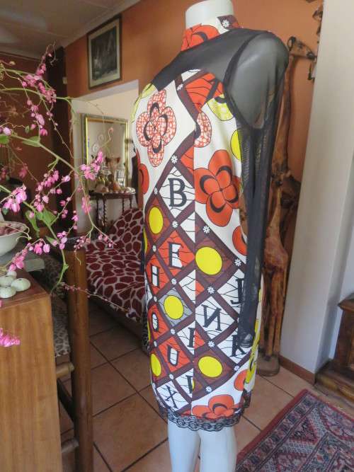 Ethnic look cream dress with bold autumn design.Black long sheer sleeves and yoke.Size 36 by ENVY.