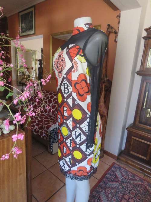 Ethnic look cream dress with bold autumn design.Black long sheer sleeves and yoke.Size 36 by ENVY.