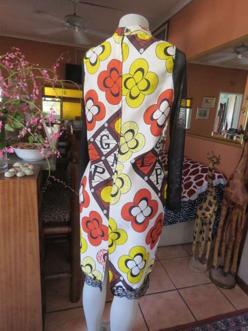 Ethnic look cream dress with bold autumn design.Black long sheer sleeves and yoke.Size 36 by ENVY.