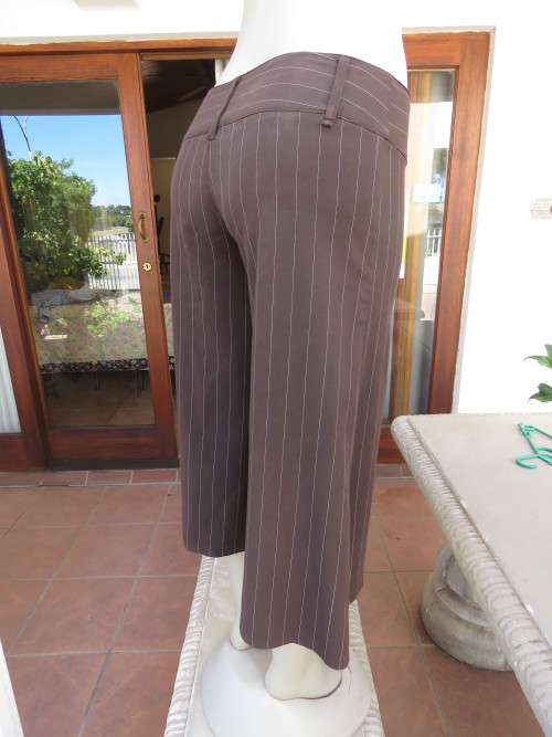 Choc brown wide legged skirt pants calf length with thin white vertical stripes.Zip on front.Size 32