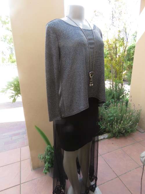Glitter long sleeve slip over top in polyester,viscose,metalic silver.Size 36 to 38 by H+M As new