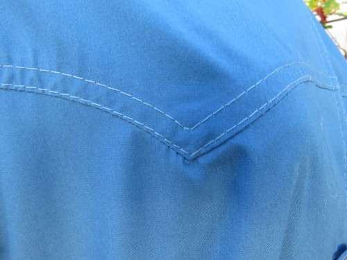 As new original RUDCO light weight steel blue chesterfield button down coat size 38/14.With belt.