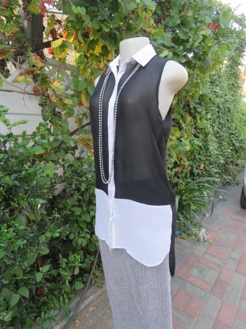 Sweet black/white sheer polyester button down top with white shirt collar.Longer back.Size 32 to 34