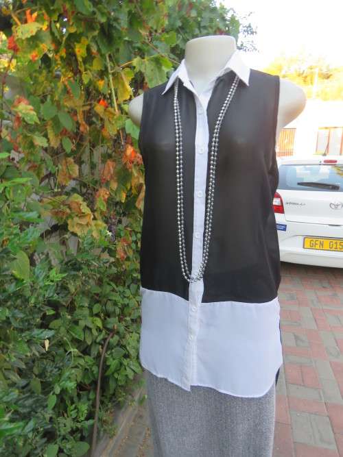Sweet black/white sheer polyester button down top with white shirt collar.Longer back.Size 32 to 34