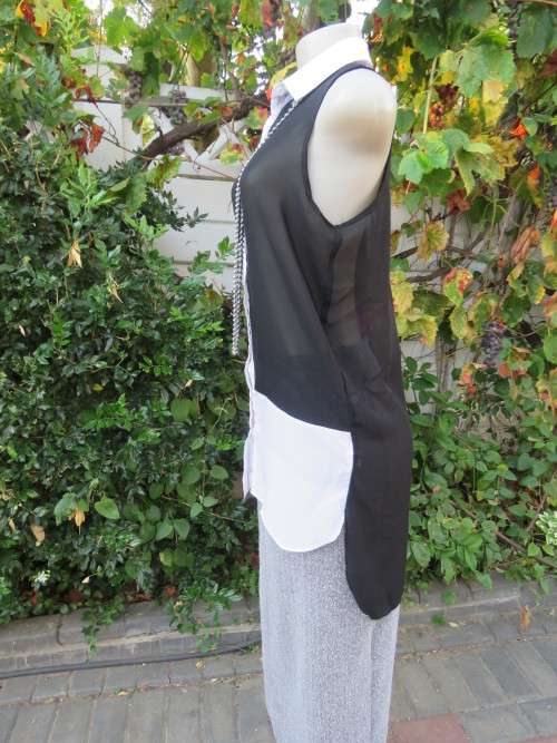 Sweet black/white sheer polyester button down top with white shirt collar.Longer back.Size 32 to 34