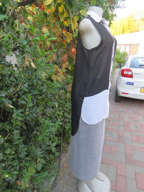 Sweet black/white sheer polyester button down top with white shirt collar.Longer back.Size 32 to 34