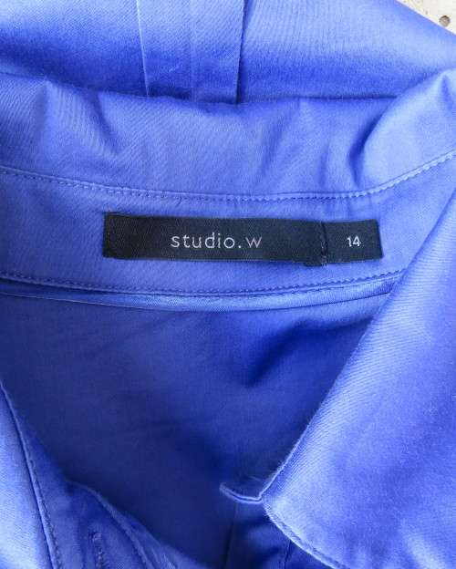 High quality long sleeve royal blue top by STUDIO W size 38/14.Hidden button down and shirt collar.