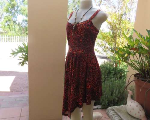 Get noticed in this brick and black high/low animal print poly stretch dress.By WWW size 36.