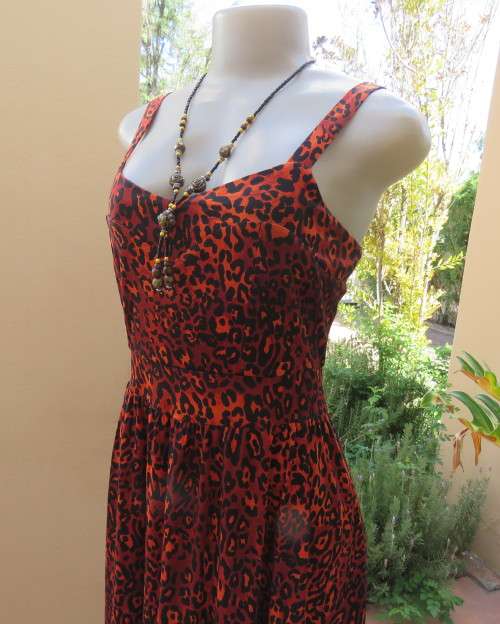 Get noticed in this brick and black high/low animal print poly stretch dress.By WWW size 36.