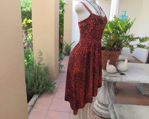 Get noticed in this brick and black high/low animal print poly stretch dress.By WWW size 36.