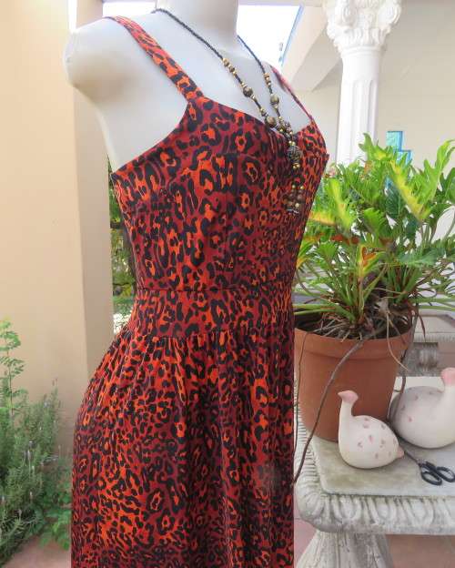 Get noticed in this brick and black high/low animal print poly stretch dress.By WWW size 36.