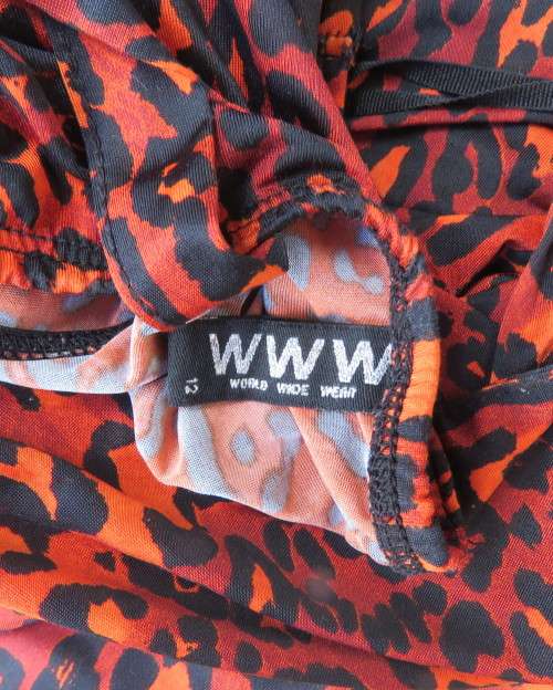 Get noticed in this brick and black high/low animal print poly stretch dress.By WWW size 36.