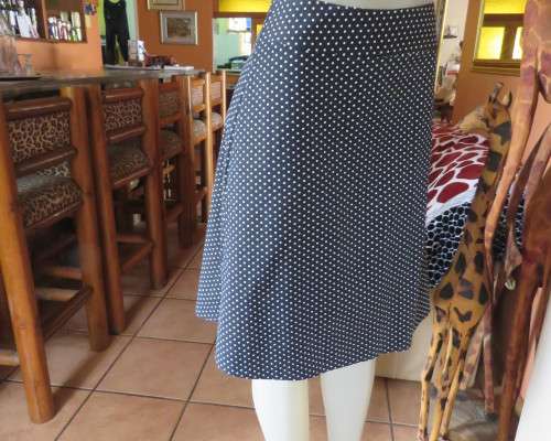 Easy to wear black A-Line calf length skirt with white polkadots.Yoke style waistband.Size 40/16.