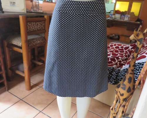 Easy to wear black A-Line calf length skirt with white polkadots.Yoke style waistband.Size 40/16.