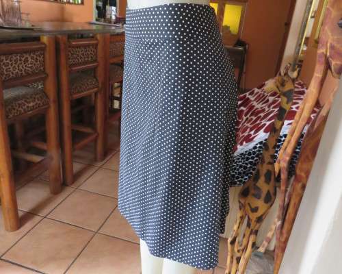 Easy to wear black A-Line calf length skirt with white polkadots.Yoke style waistband.Size 40/16.