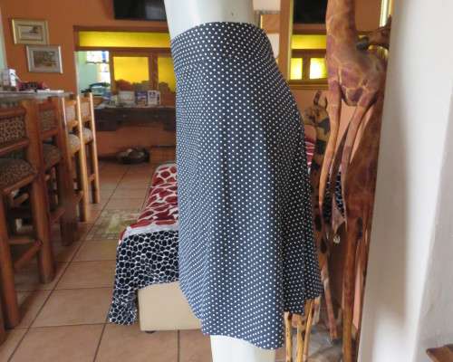 Easy to wear black A-Line calf length skirt with white polkadots.Yoke style waistband.Size 40/16.