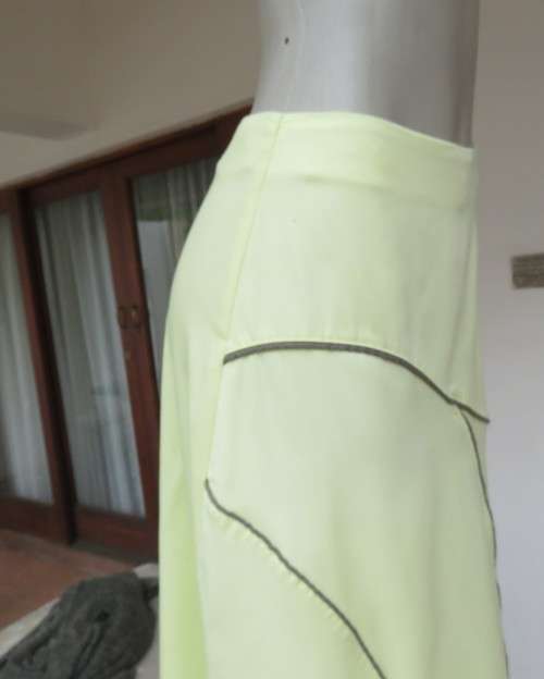 Lemon yellow ankle length A-Line paneled skirt with olive green edging in panels.Size 34/10.As new