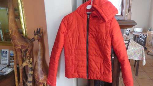 As new red padded long sleeve hooded jacket size 30/6 by RT. Kangaroo pockets.100% polyester.